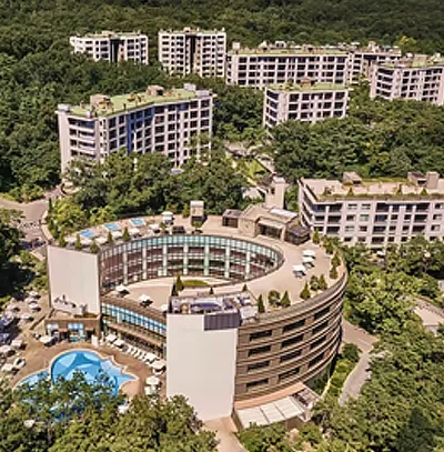 Aerial view of ANTO, a high-end resort set amid forested mountains in South Korea, with modern architecture.