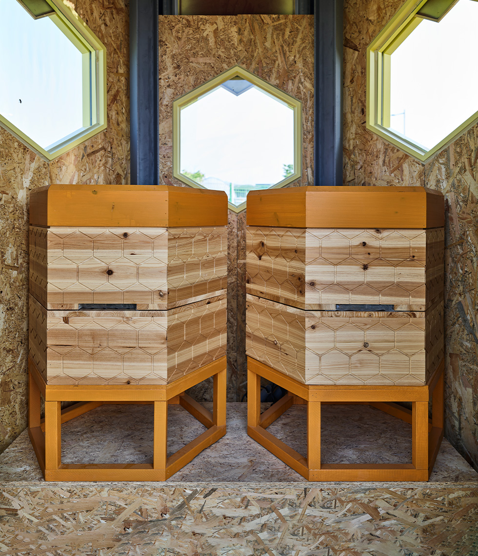 Inside the Solar Beehive are two wooden beehives that are monitored by the smart system.