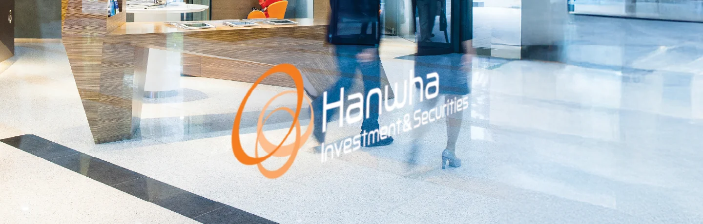 Lobby of Hanwha Investment & Securities with logo reflected on glass wall.