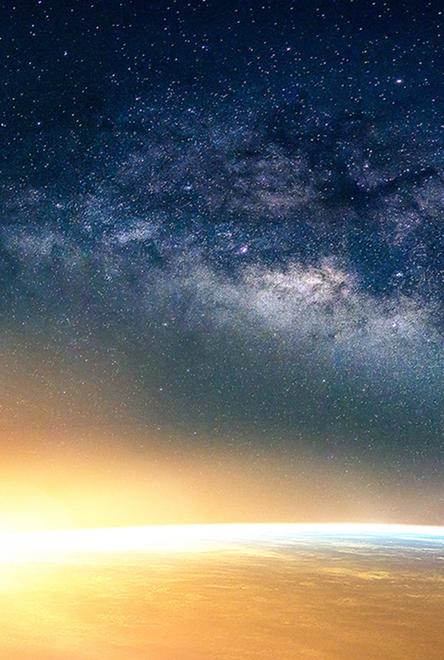 Earth illuminated by the rising sun as seen from outer space. 