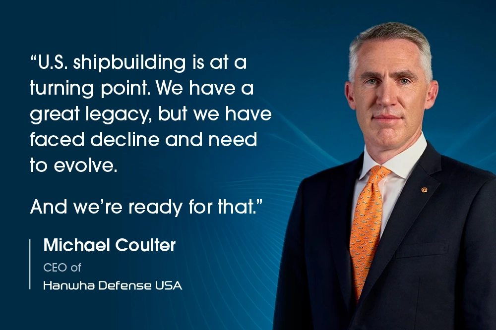 Michael Coulter, CEO of Hanwha Defense USA, beside a quote