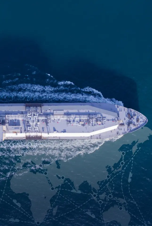 Top-down view of a large vessel sailing at sea symbolizing global shipping routes.