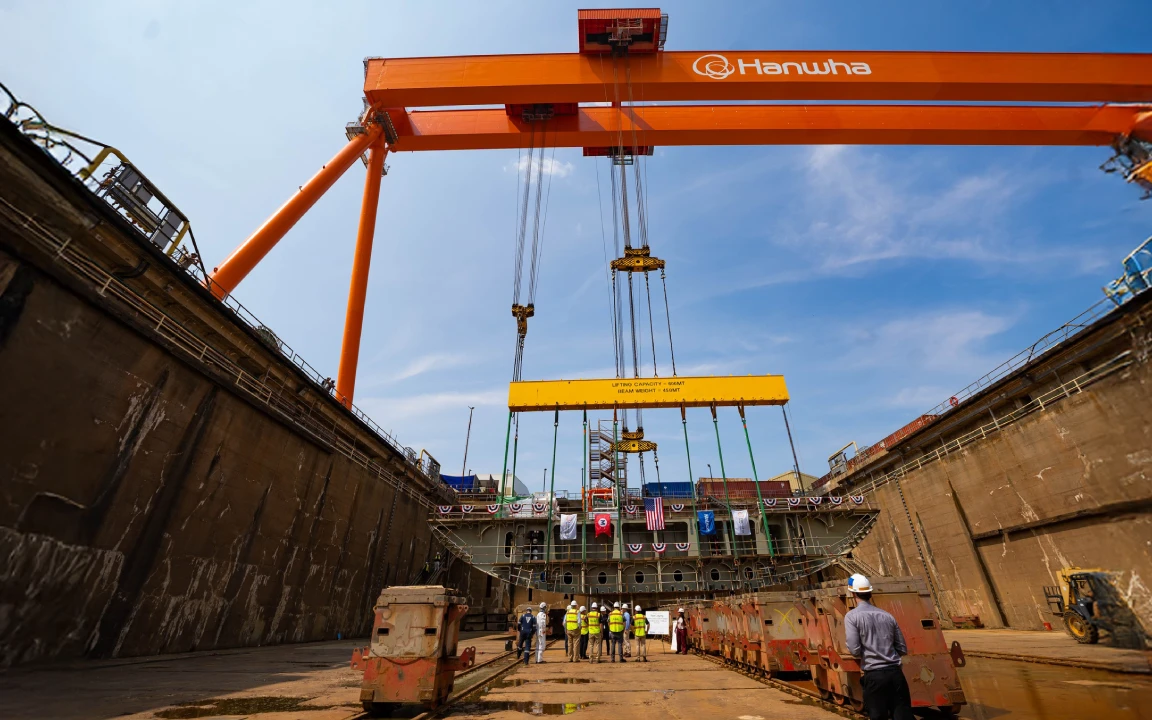 Hanwha Philly Shipyard gantry crane above crew in dry dock