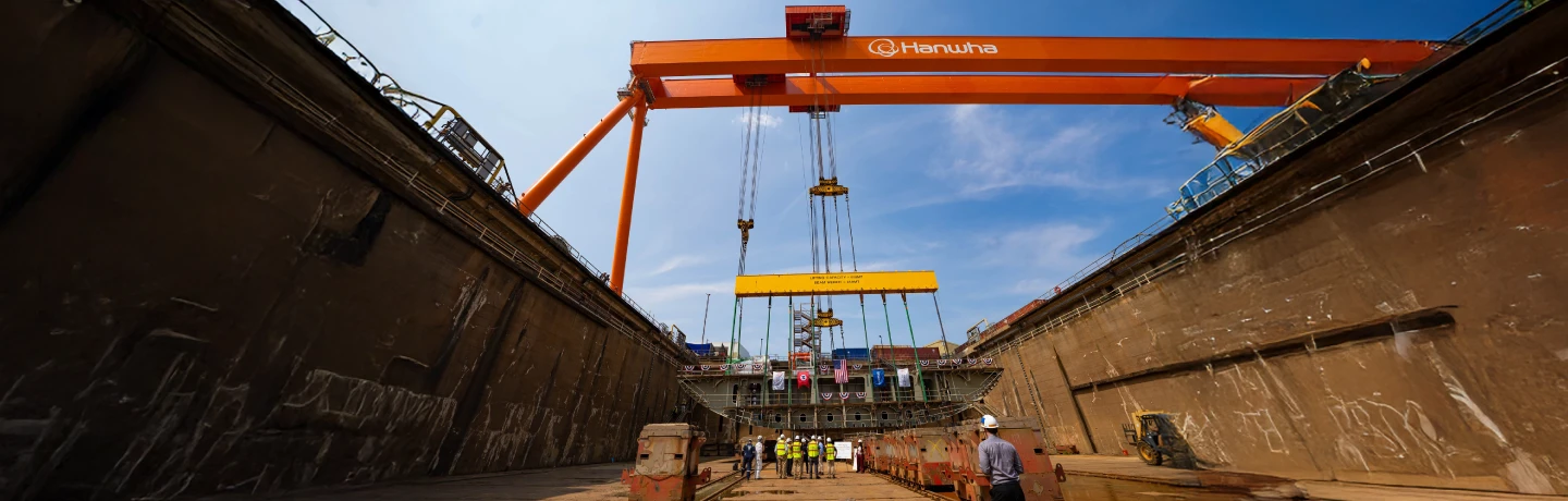 Hanwha Philly Shipyard gantry crane above crew in dry dock