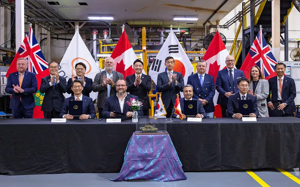 Republic of Korea officials and Canadian industry leaders display a signed Canada-Korea partnership agreement.